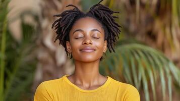 A woman with dreadlocks is meditating photo