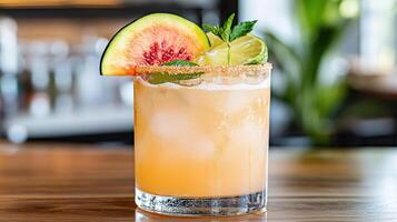 A drink with a slice of fruit and a lime photo