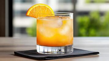 A glass of orange juice with an orange slice on the side photo