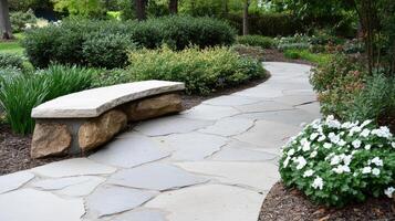 A stone bench in a garden with flowers and plants photo