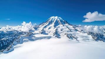 A mountain covered in snow with clouds in the sky photo