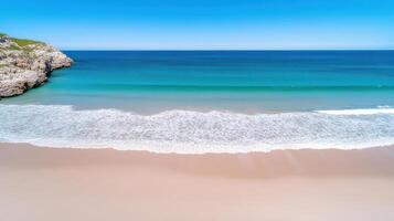 A beach with waves and blue water photo