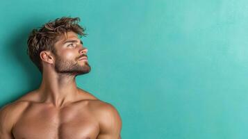 A shirtless man looking up at the sky photo