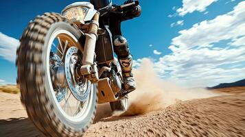 A person riding a motorcycle on a dirt road photo