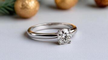 A diamond engagement ring sits on top of a christmas tree photo