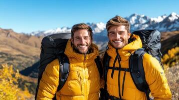 Two men in yellow jackets standing on a mountain photo