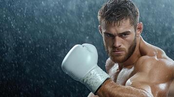A man in boxing gloves is posing in the rain photo