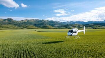 A helicopter flying over a green field with mountains in the background photo