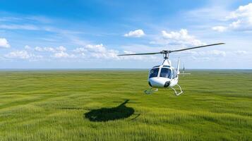 A helicopter flying over a field of green grass photo