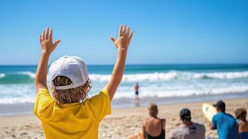 A child with his hands up on the beach photo