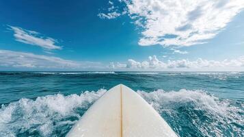 Surfboard in the ocean with waves and blue sky photo