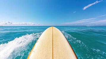 A surfboard is seen from above in the ocean photo