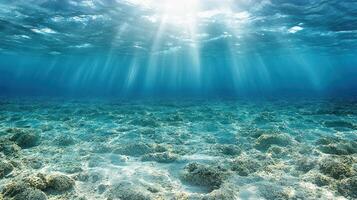 Underwater view of the ocean with sunlight shining through the water photo
