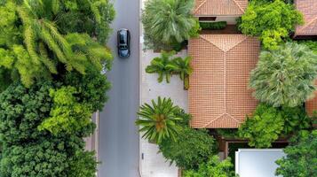 Aerial view of a house with a car on the road photo