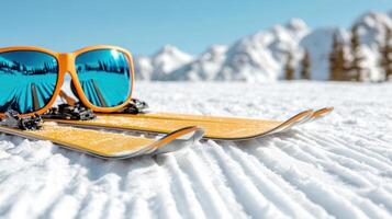 Two pairs of sunglasses and skis on the snow photo