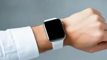 A person wearing a white shirt and a black apple watch photo
