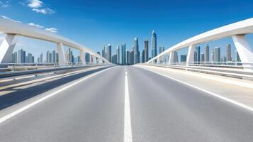 A highway with a bridge over it and a city in the background photo