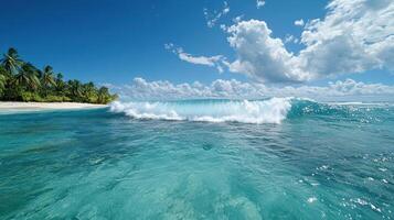 A wave breaking on the beach near a tropical island photo