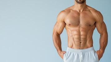 A man with a shirtless body standing in front of a blue background photo