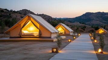 A group of tents in the desert with candles lit photo
