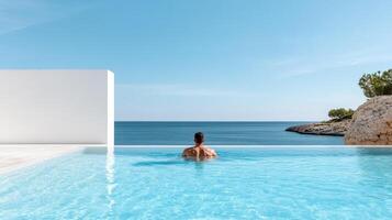 A woman sitting in the pool of a luxury resort photo