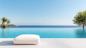White ottoman sitting on the edge of a pool with the ocean in the background photo