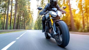 A person riding a motorcycle on a road in the woods photo
