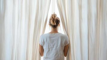 A woman standing in front of a curtain photo