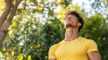 A man in a yellow shirt is looking up photo