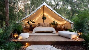 A tent with a bed and a table in the middle of a wooded area photo