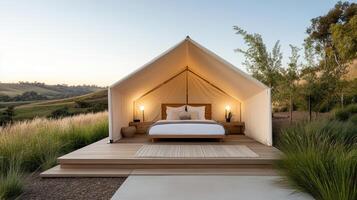 A tent with a bed on top of a wooden deck photo