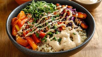 A bowl of food with vegetables and dressing on it photo