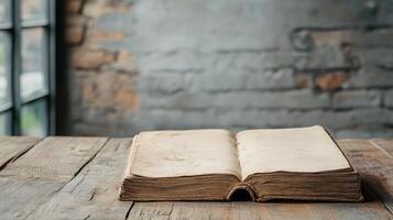 An old book on a wooden table in front of a window photo