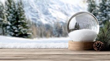 A snow globe on a wooden table with pine cones photo