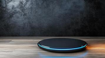 A black and blue smart speaker on a wooden table photo