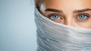 A woman with blue eyes covered in a scarf photo