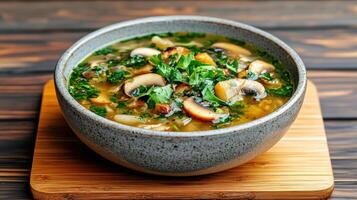 A bowl of soup on a wooden table photo