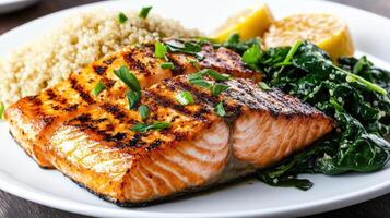 Grilled salmon with greens and rice on a white plate photo