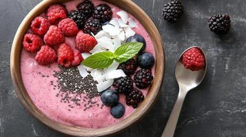 Pink smoothie bowl with berries and mint photo