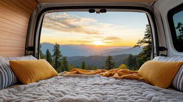 A bed in a camper van with a view of the mountains photo