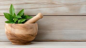 A wooden mortar with a green plant in it photo