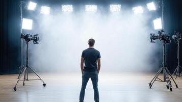 A man standing in front of a stage with lights photo