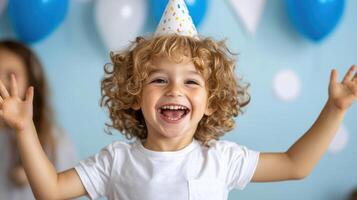 A young boy with a birthday hat on his head photo