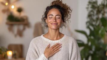 A woman is smiling while sitting in a yoga pose photo