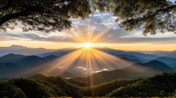 The sun shines over a mountain range in the morning photo