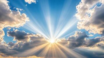 Sunbeams shining through clouds in a blue sky photo
