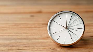 A clock with a broken face on a wooden table photo