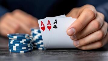 A man holding a pair of aces and playing cards photo