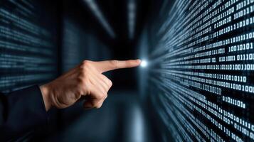 A hand pointing at a binary code on a computer screen photo