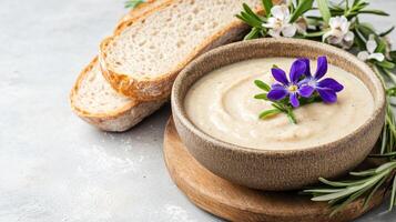 A bowl of soup with bread and rosemary photo